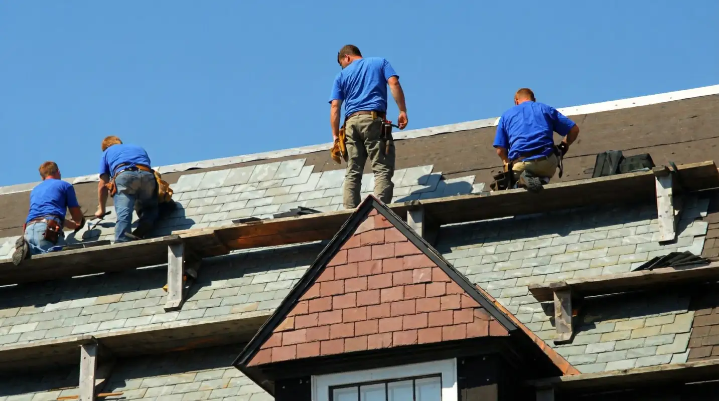 Roof replacement in progress with a team of professional contractors installing new shingles on a residential home in Knoxville, TN