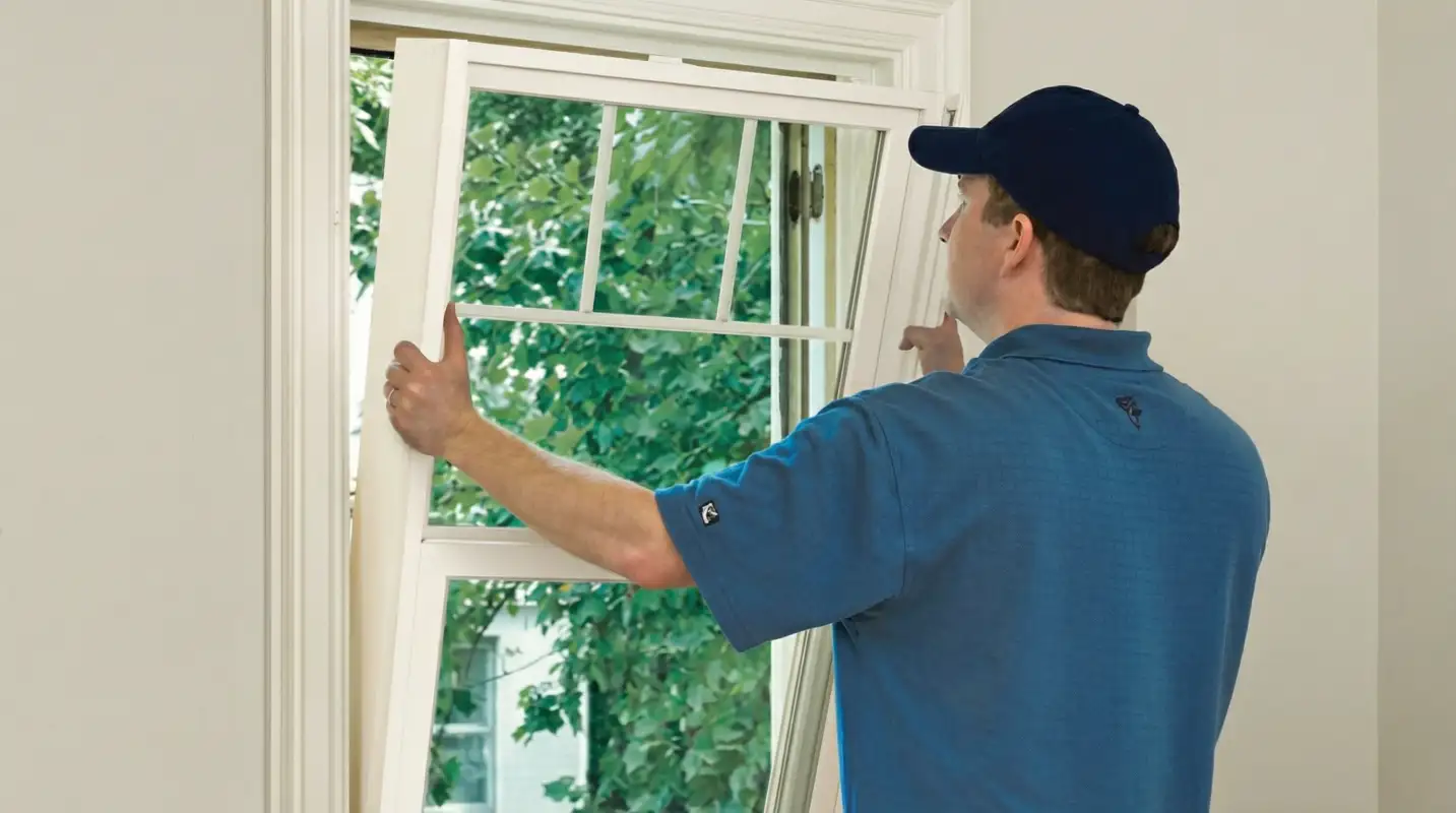 Professional contractors performing a residential window insulation and replacement service in Knoxville, TN